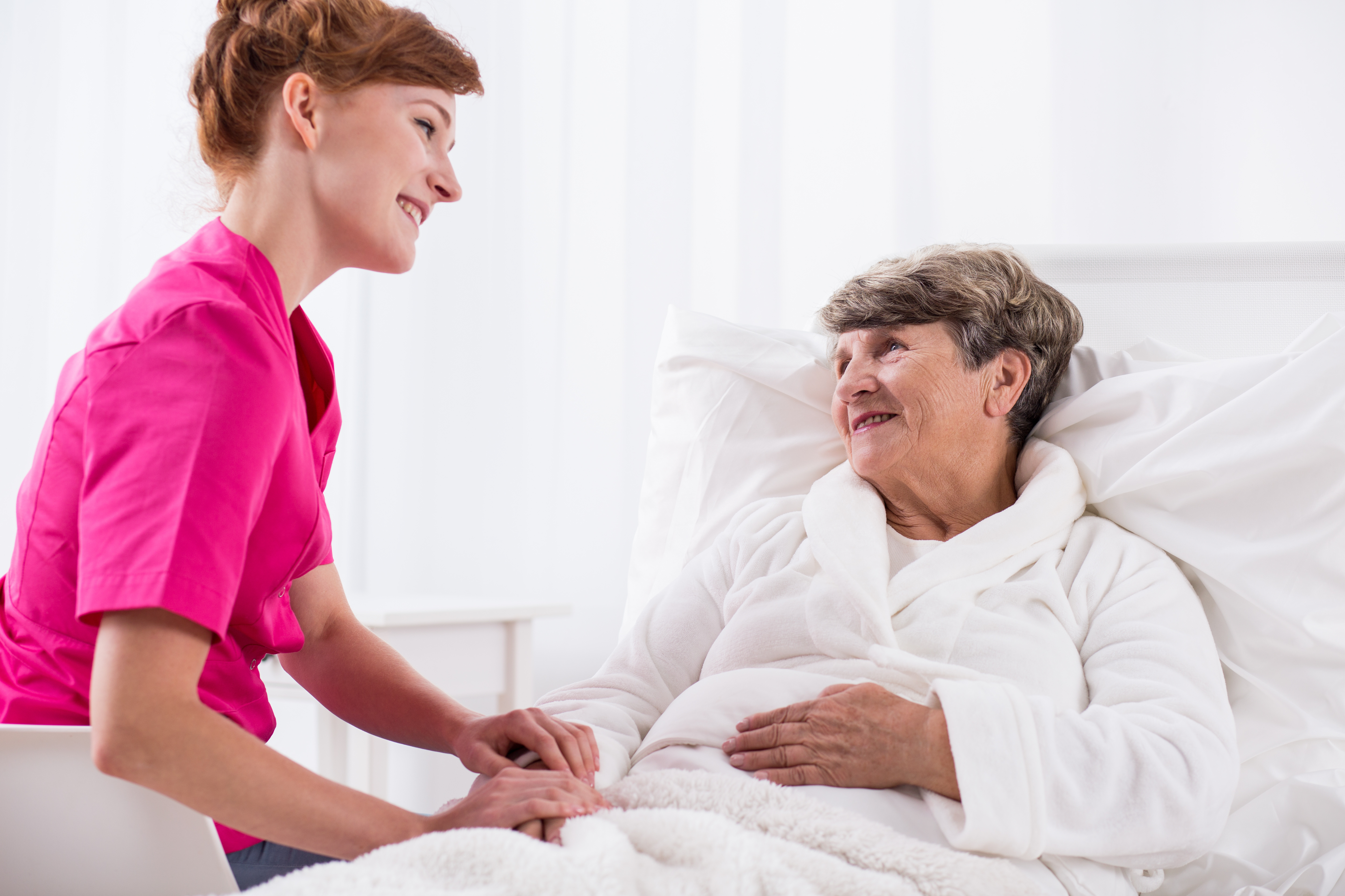 Picture of happy nurse and ill hospital patient